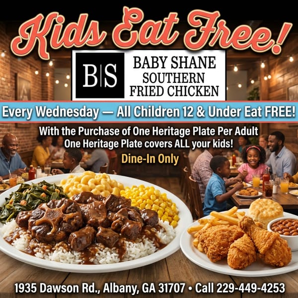 Plates of oxtails and fried chicken with sides, with families dining in the background.