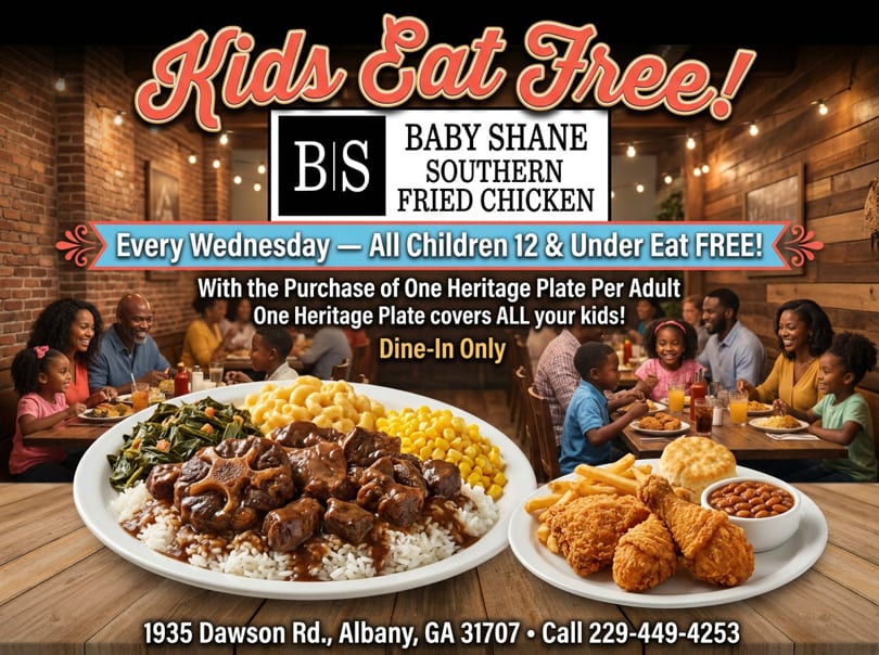 Plates of oxtails and fried chicken with sides, with families dining in the background.